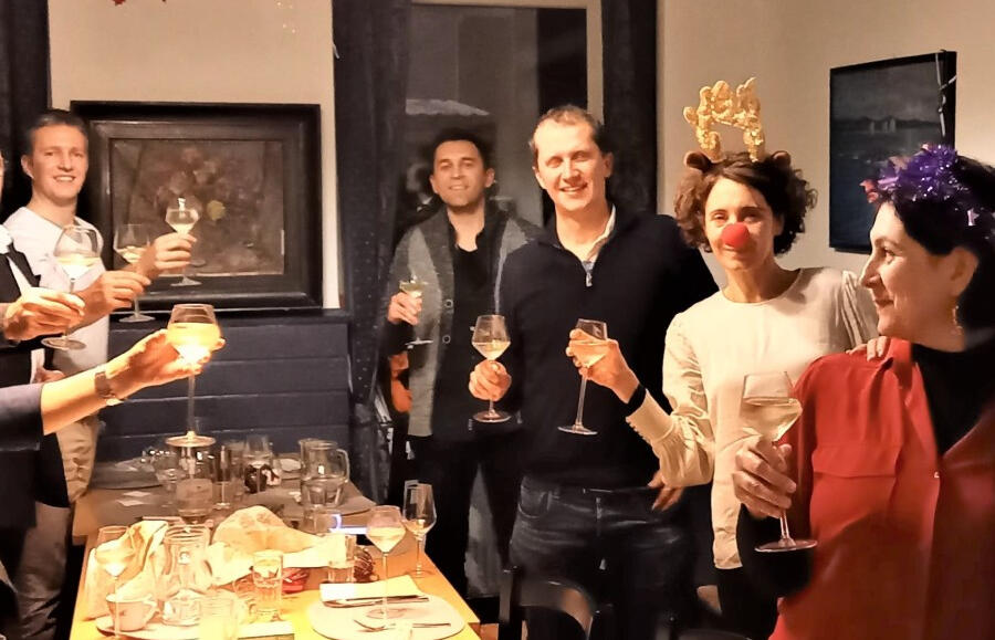 Giving a toast a group of people standing and holding glasses